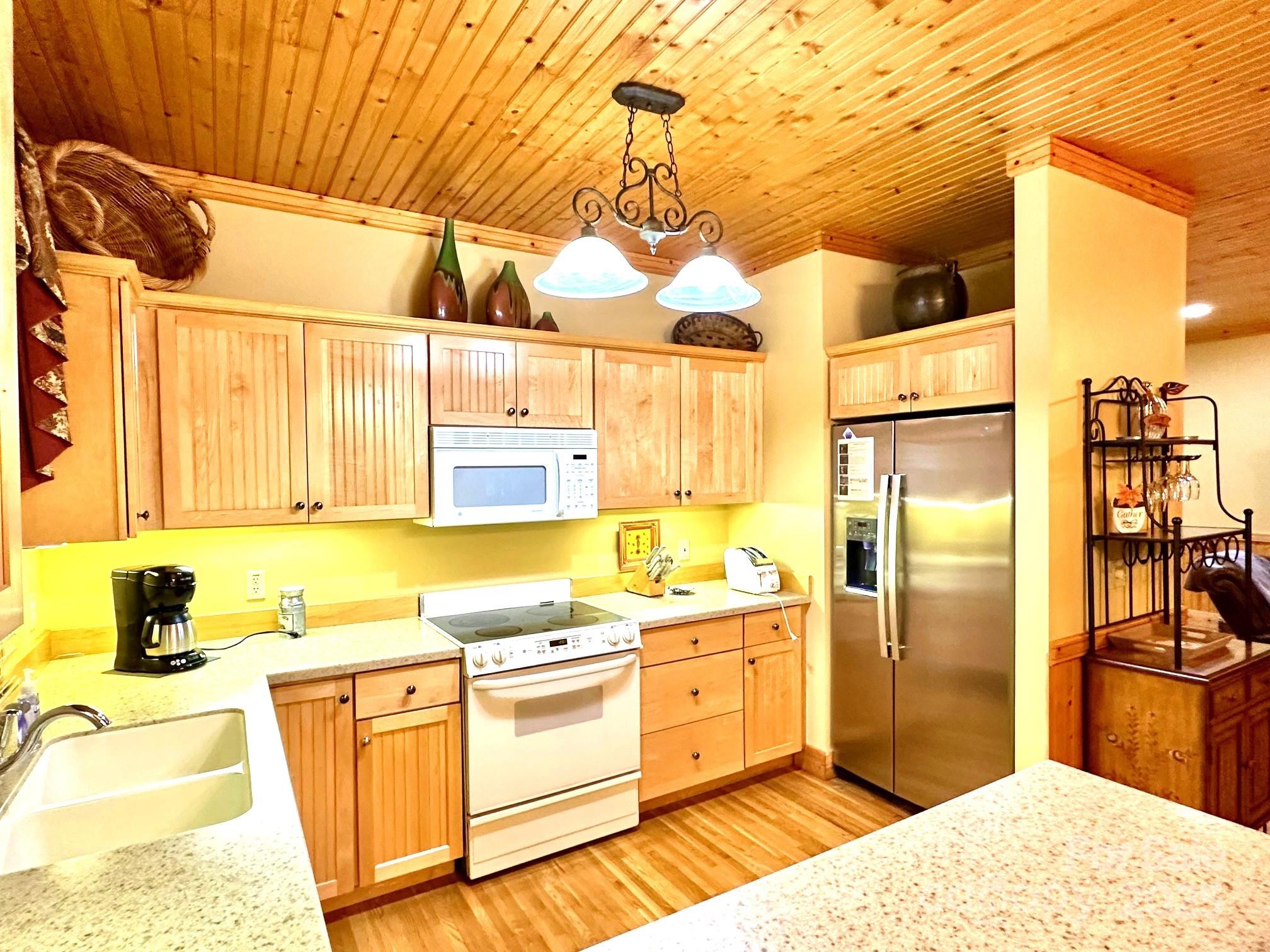 56 First Tee Trail Cashiers, NC 28717 - Photo 14 of 37 a kitchen with stainless steel appliances kitchen island granite countertop a sink and cabinets
