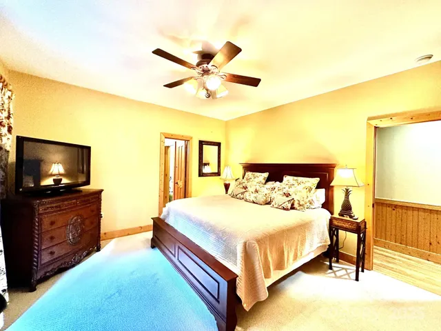 a bed room with a bed and a chair