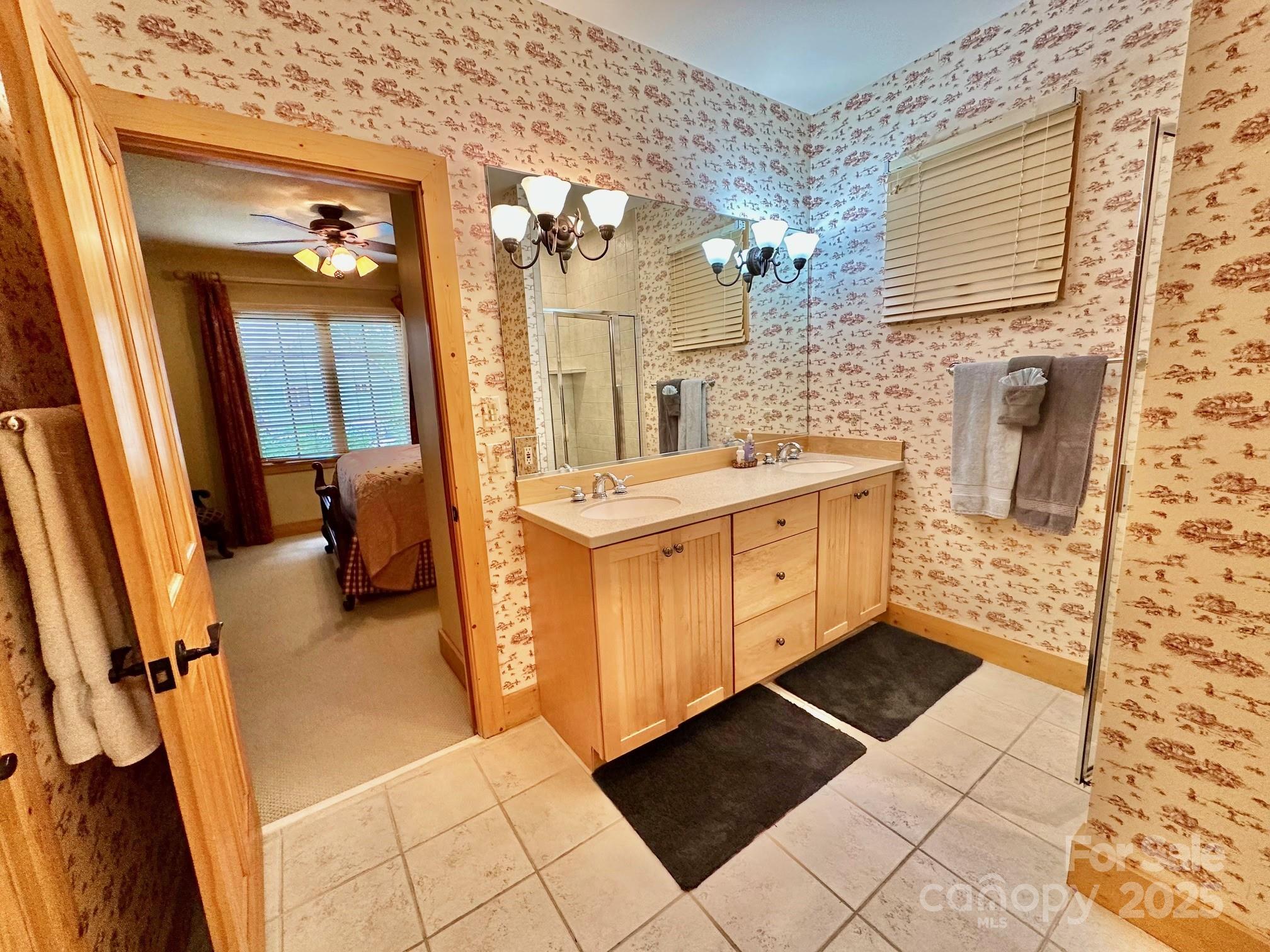 56 First Tee Trail Cashiers, NC 28717 - Photo 19 of 37 a bathroom with a sink a toilet and shower