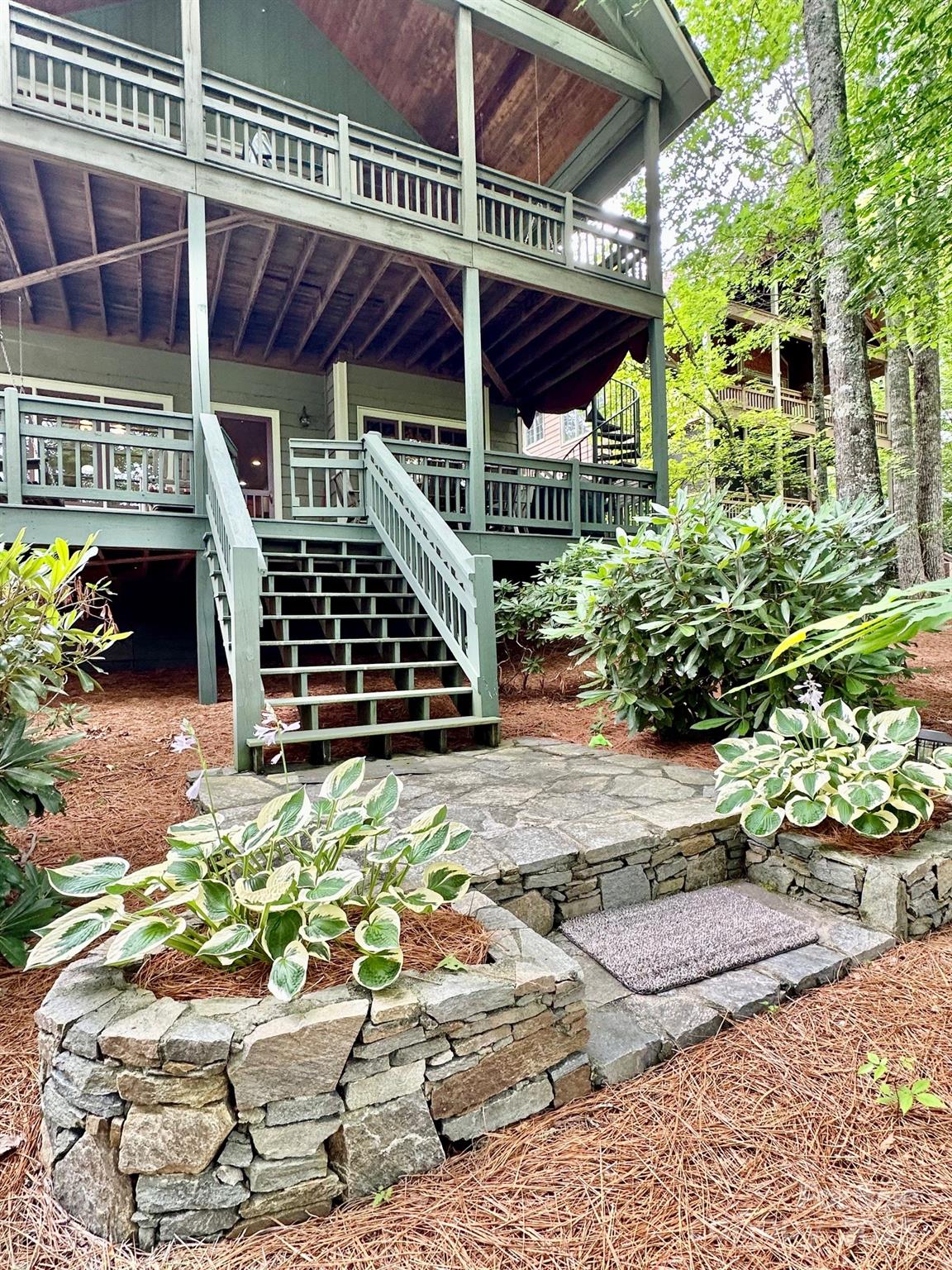 56 First Tee Trail Cashiers, NC 28717 - Photo 24 of 37 a view of a patio with table and chairs potted plants