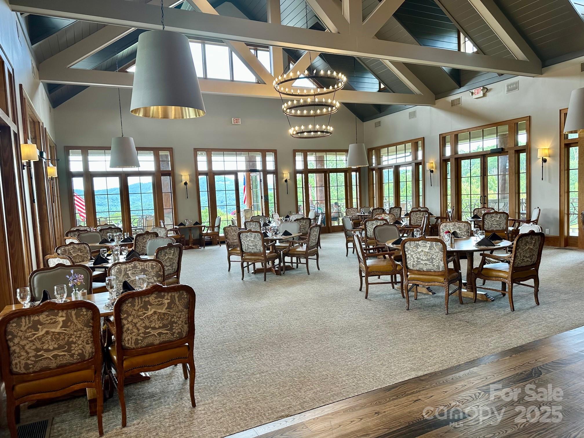 56 First Tee Trail Cashiers, NC 28717 - Photo 30 of 37 a view of a dining room with furniture a chandelier and wooden floor