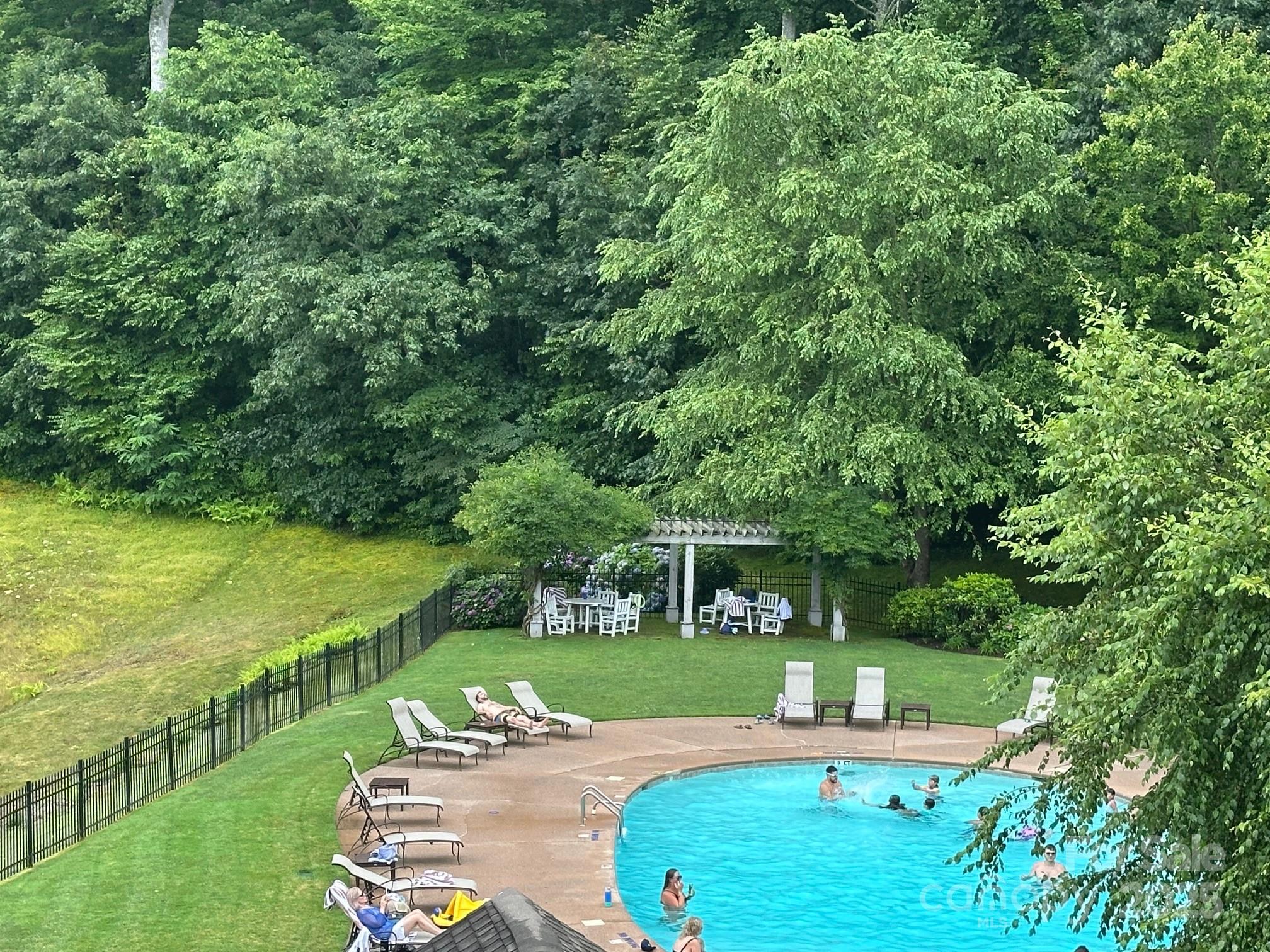 56 First Tee Trail Cashiers, NC 28717 - Photo 31 of 37 an outdoor view of house with swimming pool and yard