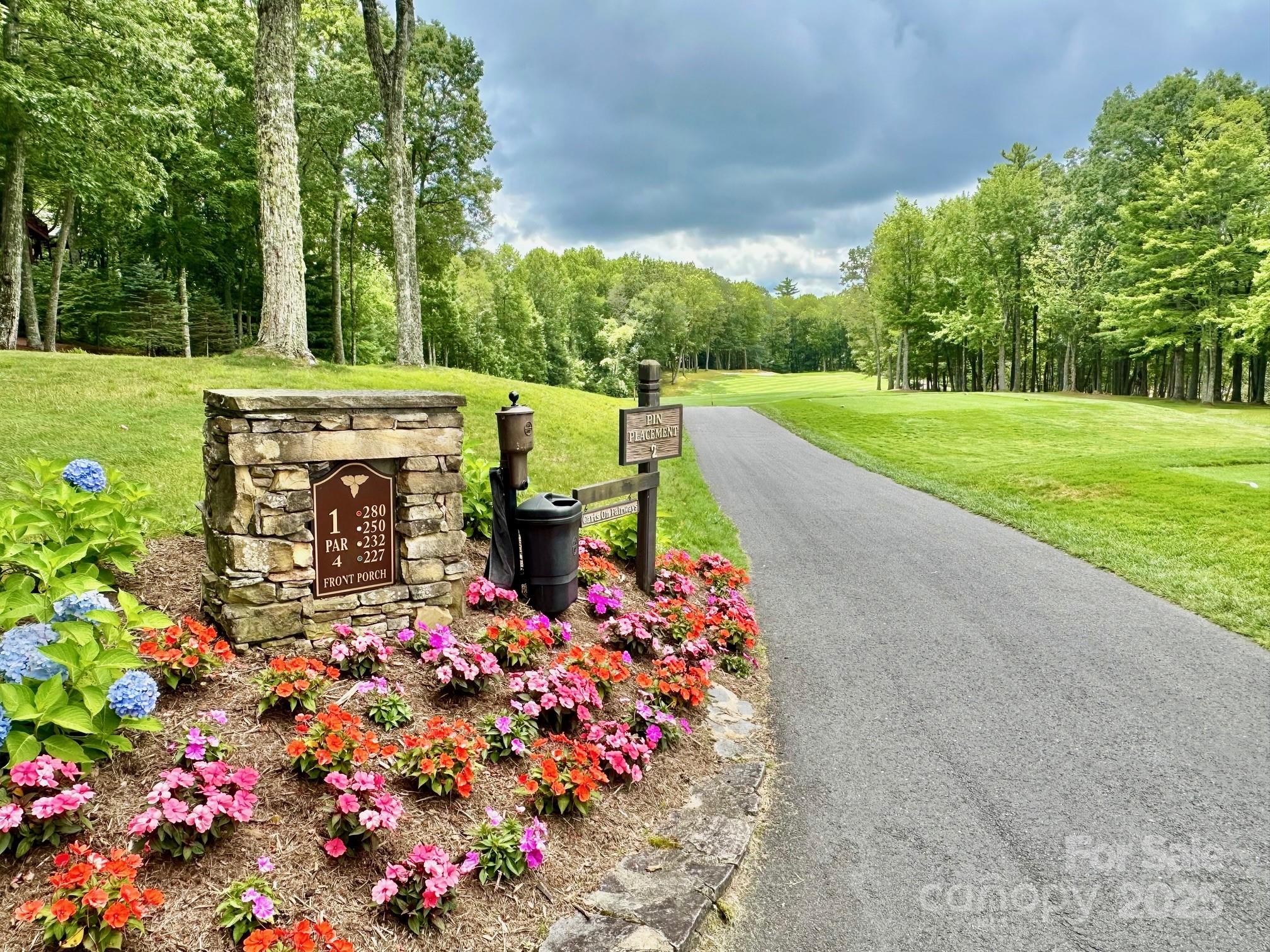 56 First Tee Trail Cashiers, NC 28717 - Photo 33 of 37 a view of a bench sitting in the middle of a park