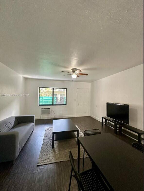 7035 Rue Granville Miami Beach, FL 33141 - Photo 8 of 12 a living room with furniture and a flat screen tv