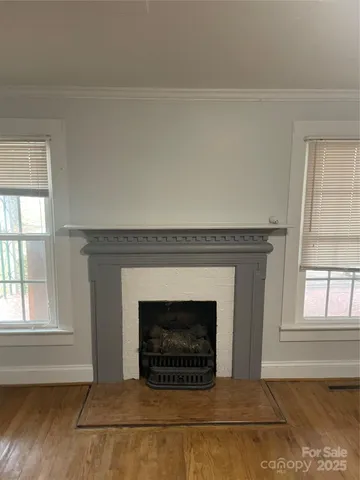 a living room with a fireplace and windows