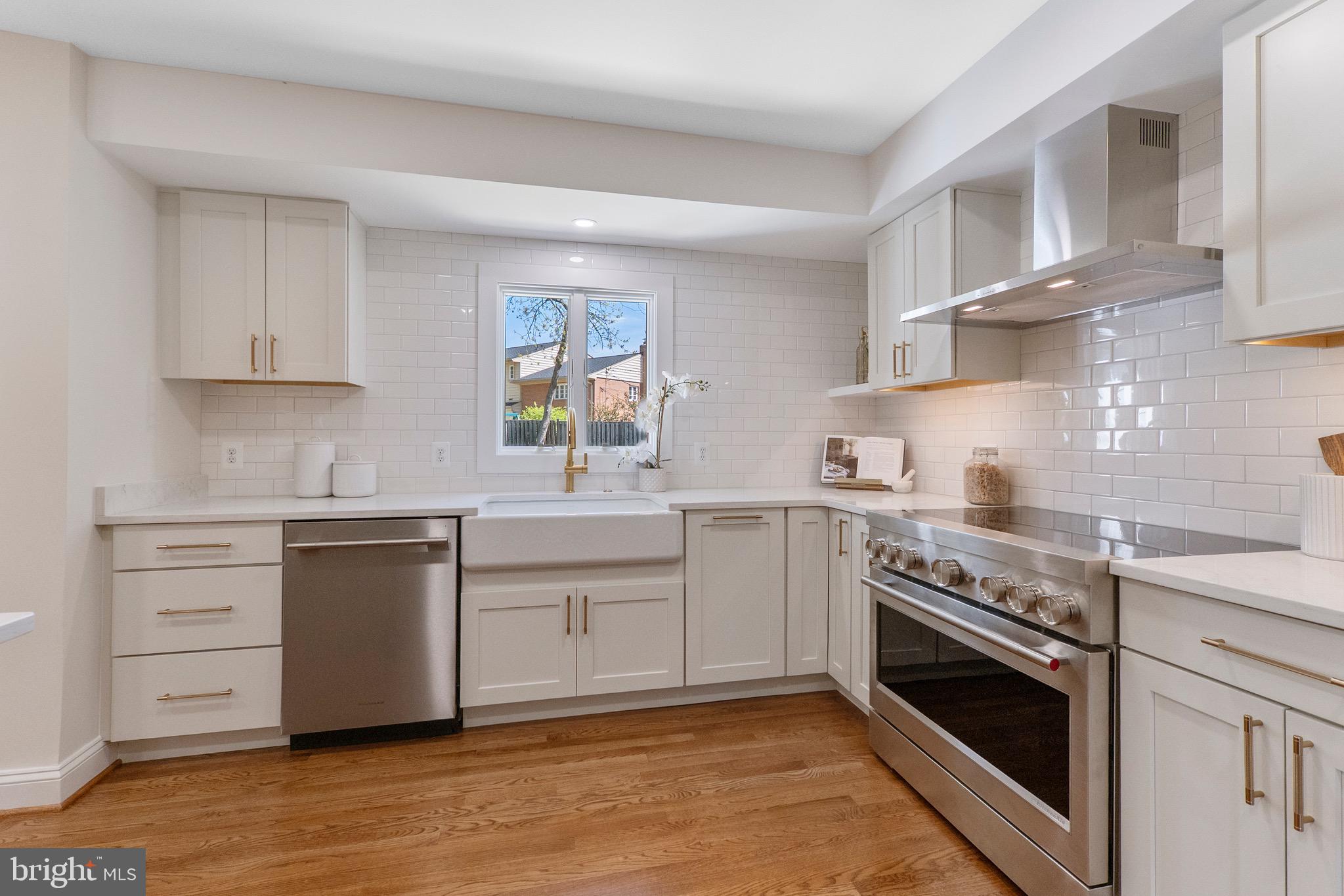 3003 Farm Road Alexandria, VA 22302 - Photo 11 of 49 a kitchen with white cabinets stainless steel appliances and sink