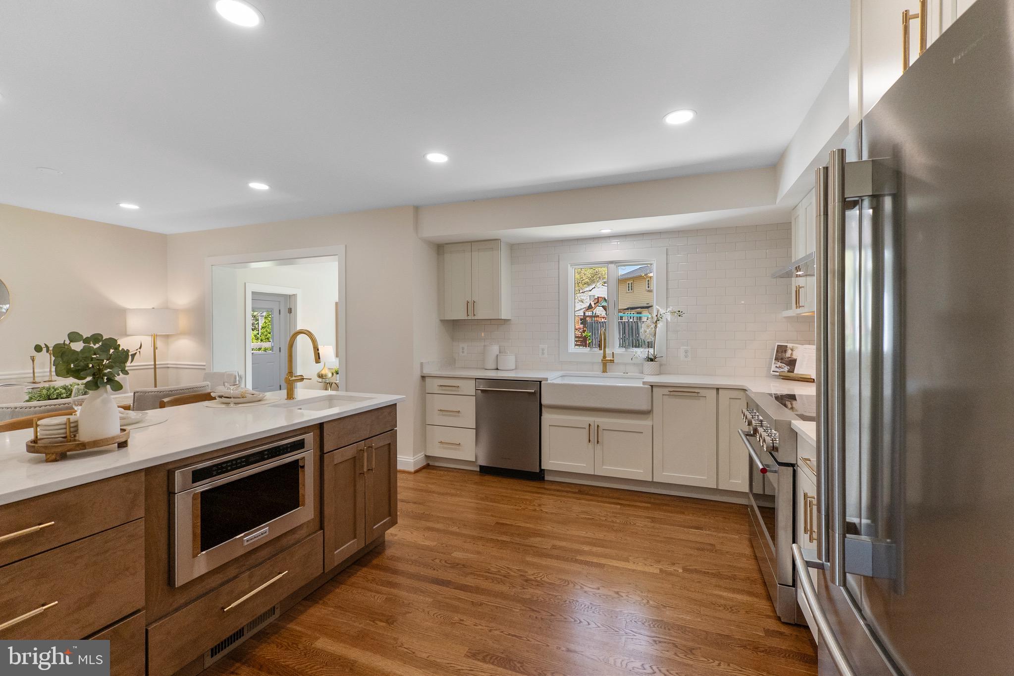 3003 Farm Road Alexandria, VA 22302 - Photo 12 of 49 a kitchen with white cabinets and stainless steel appliances