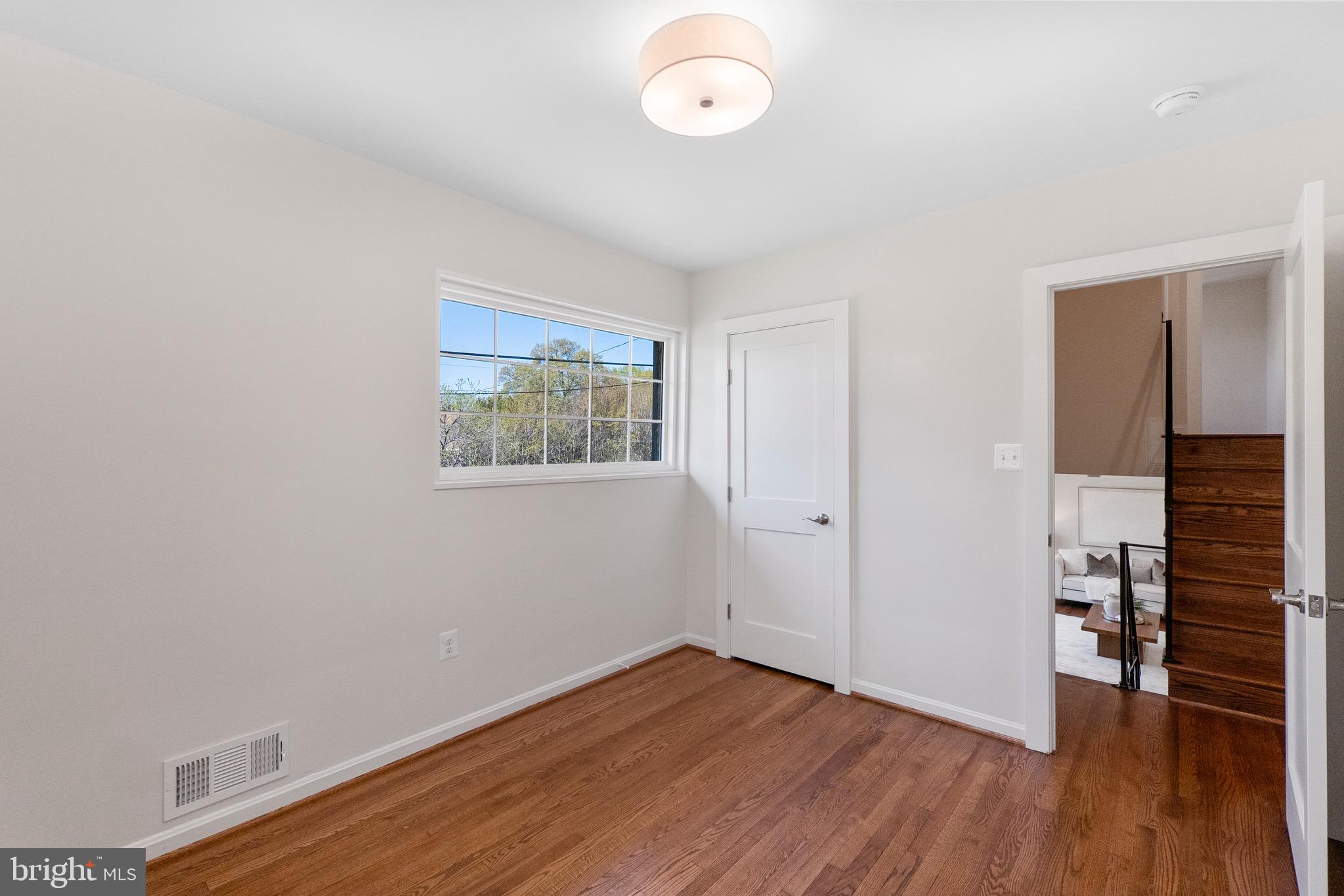 3003 Farm Road Alexandria, VA 22302 - Photo 31 of 49 an empty room with wooden floor and windows