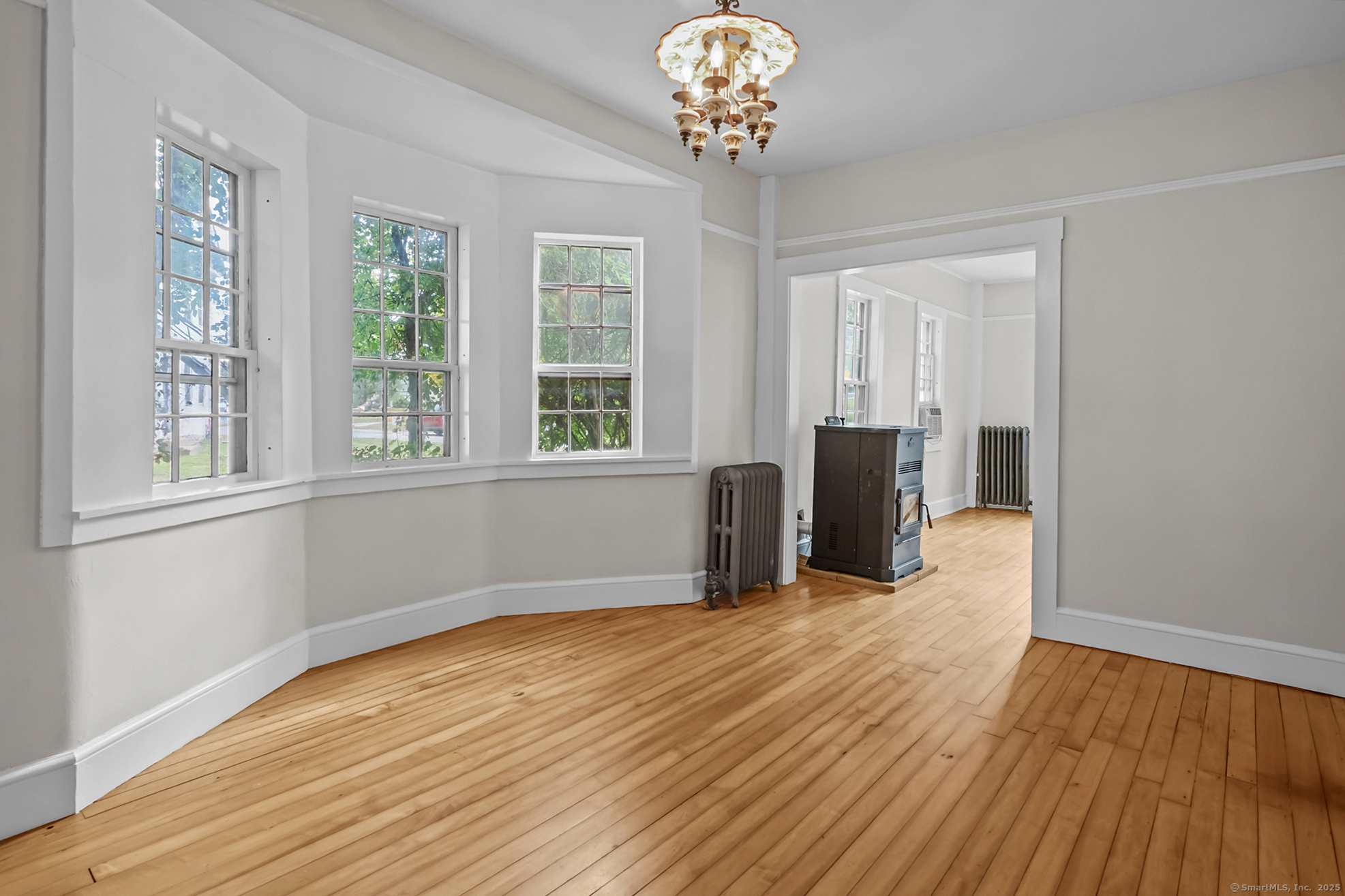 10 North Road Windham, CT 06280 - Photo 11 of 40 a view of an empty room with wooden floor and a window