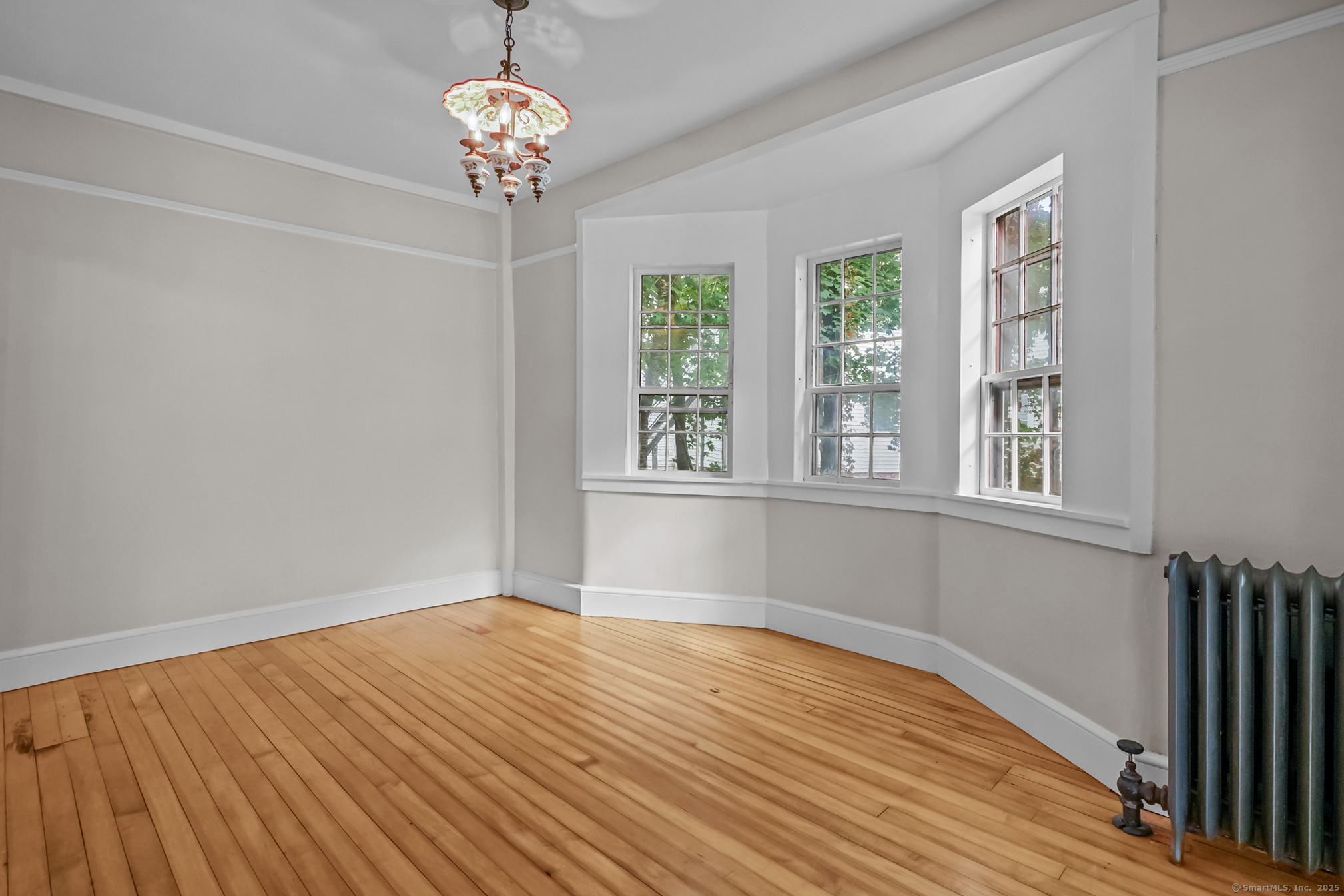 10 North Road Windham, CT 06280 - Photo 13 of 40 a view of an empty room with wooden floor and a window