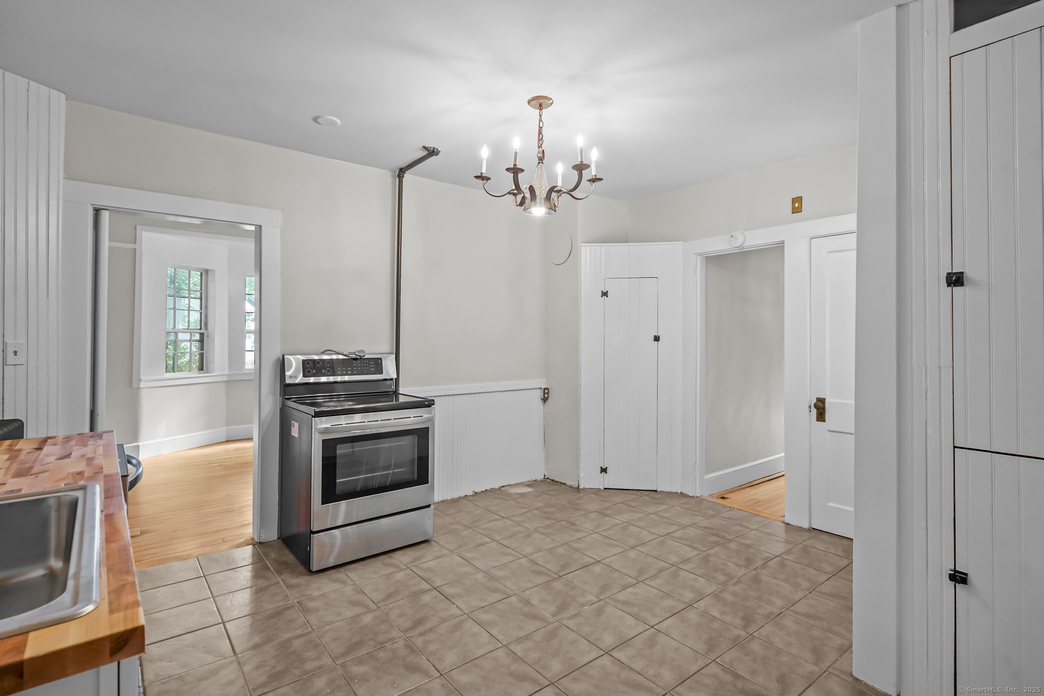 10 North Road Windham, CT 06280 - Photo 15 of 40 a view of a kitchen with a stove cabinets and a refrigerator