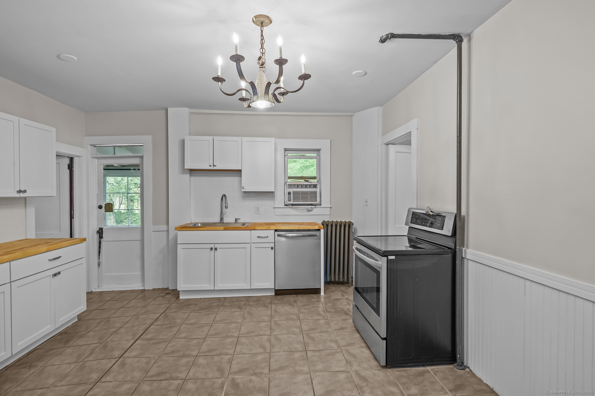 10 North Road Windham, CT 06280 - Photo 16 of 40 a kitchen with a stove a sink and a refrigerator