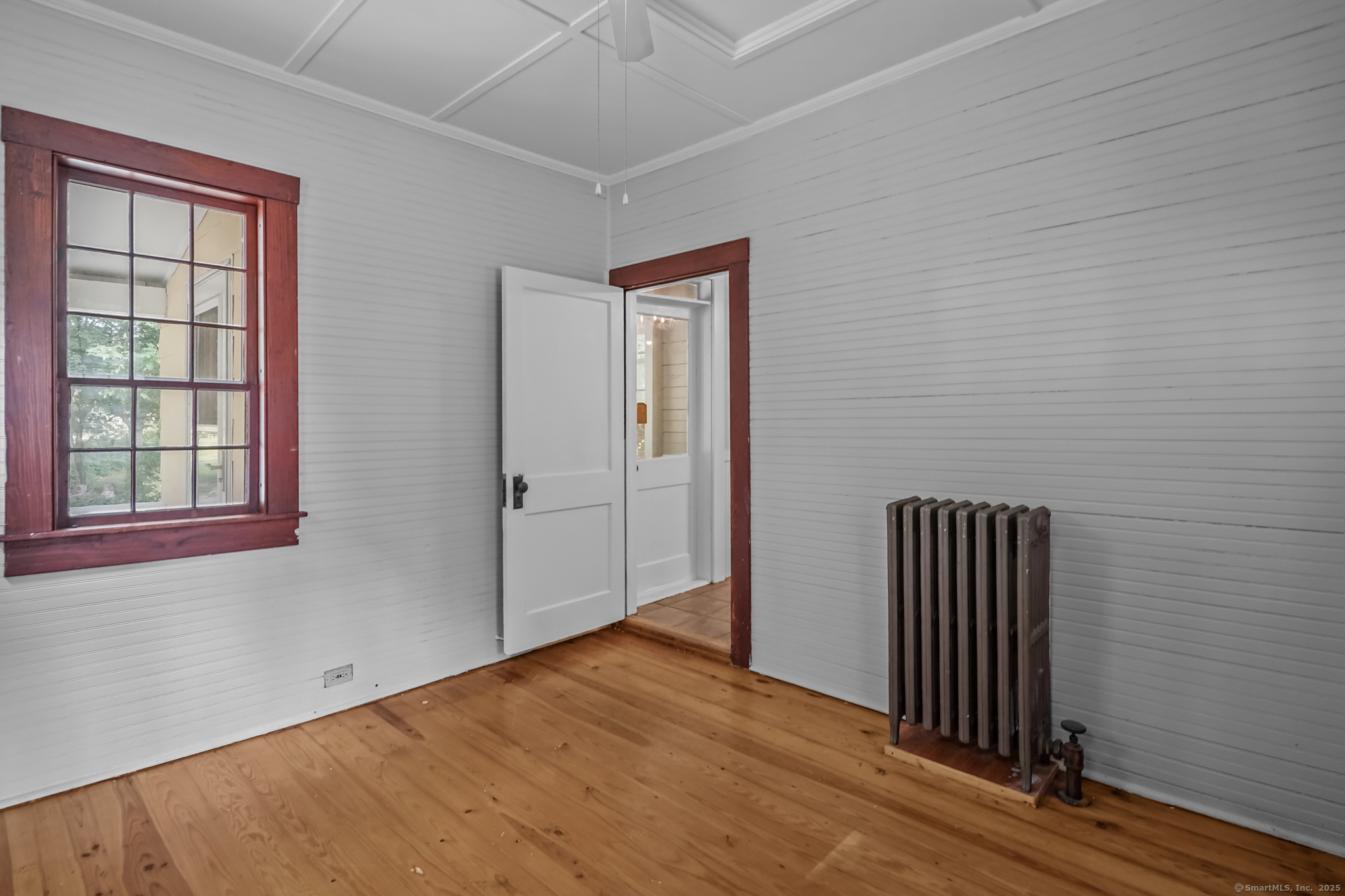 10 North Road Windham, CT 06280 - Photo 20 of 40 an empty room with a window and wooden floor