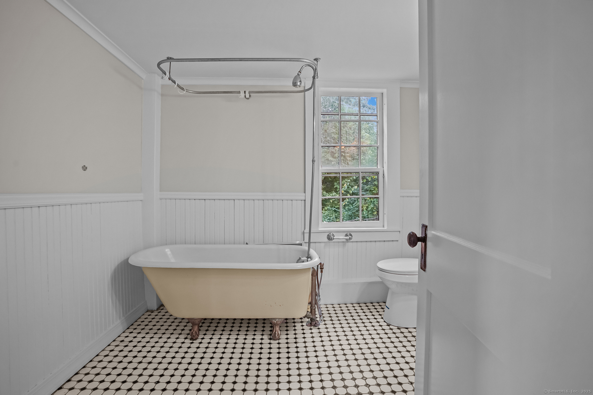 10 North Road Windham, CT 06280 - Photo 24 of 40 a bathroom with a bathtub a toilet a window and a shower