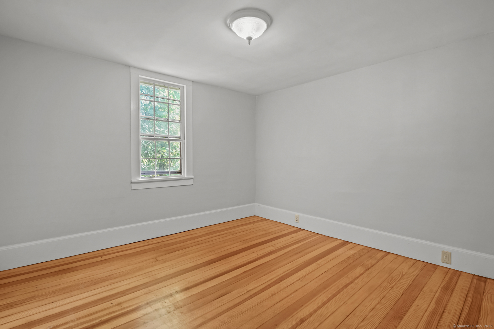 10 North Road Windham, CT 06280 - Photo 26 of 40 an empty room with wooden floor and windows