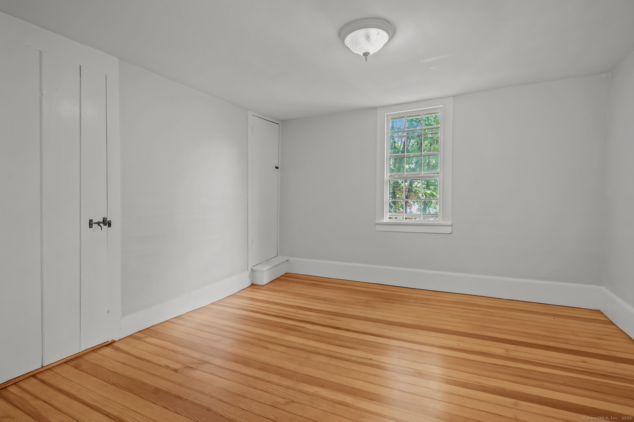 10 North Road Windham, CT 06280 - Photo 27 of 40 wooden floor in an empty room with a window