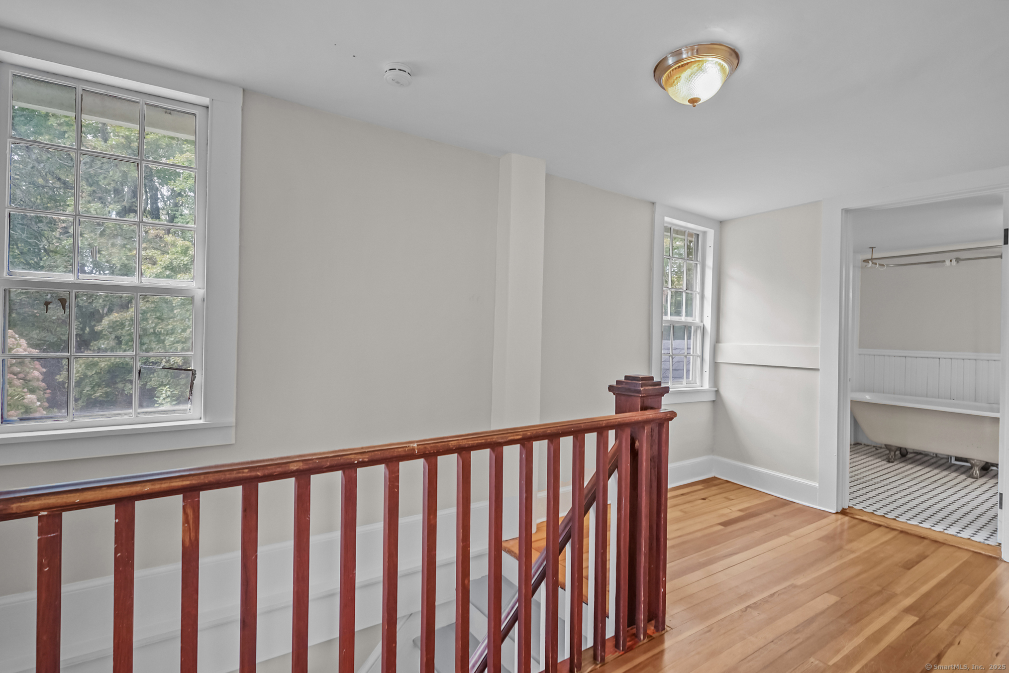10 North Road Windham, CT 06280 - Photo 29 of 40 a view of a hallway with wooden floor and a window