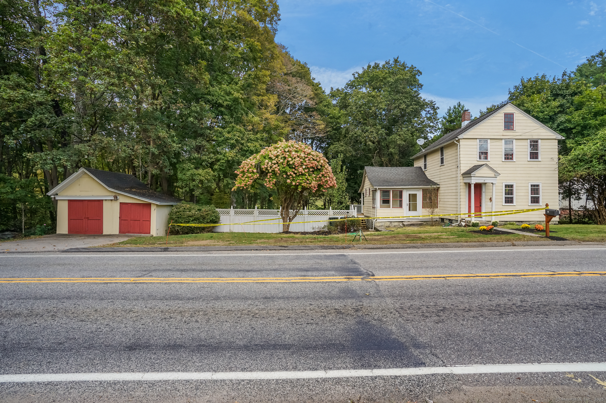 10 North Road Windham, CT 06280 - Photo 3 of 40 a view of white house with a big yard and large trees