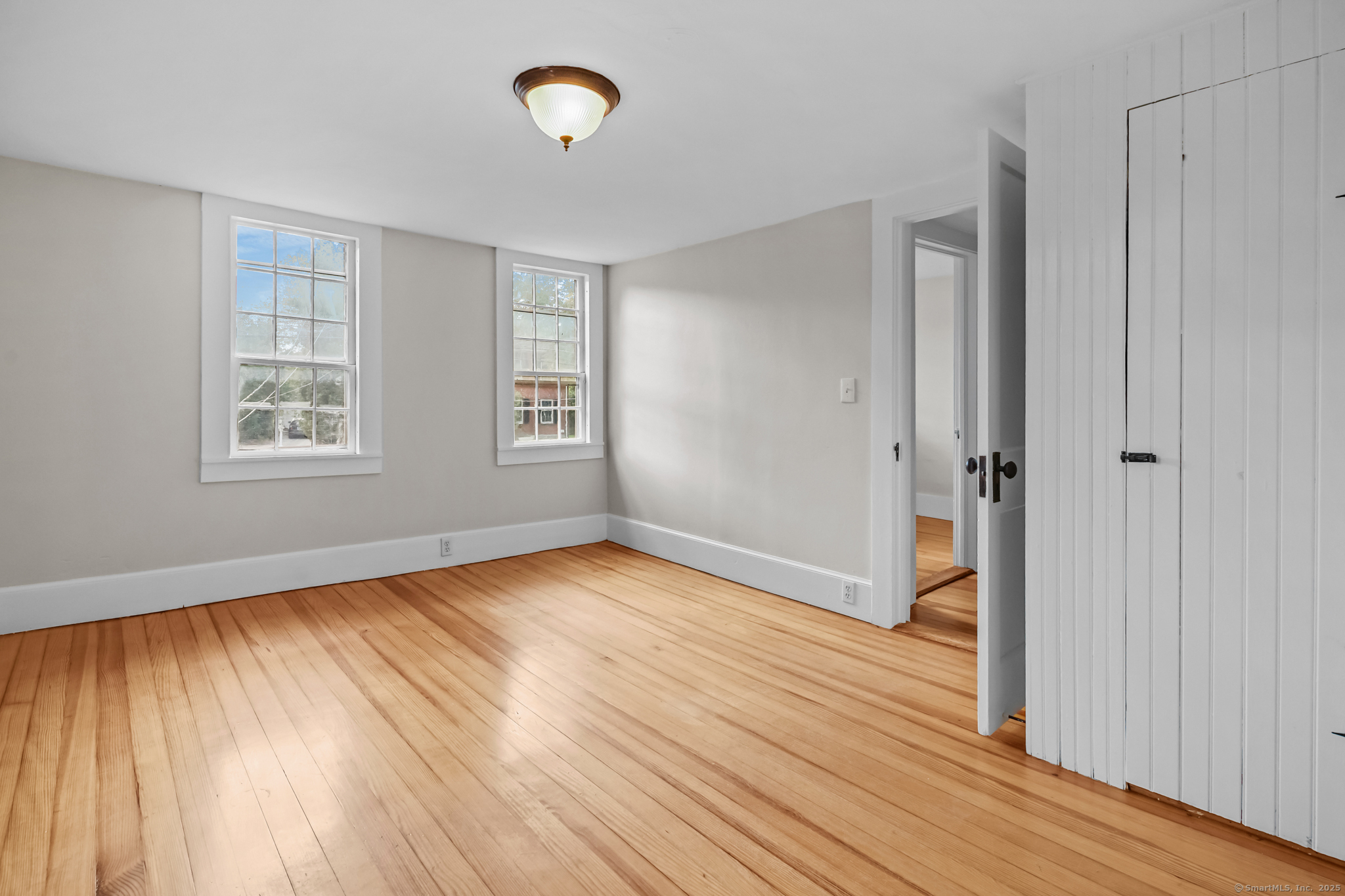 10 North Road Windham, CT 06280 - Photo 33 of 40 an empty room with wooden floor and windows