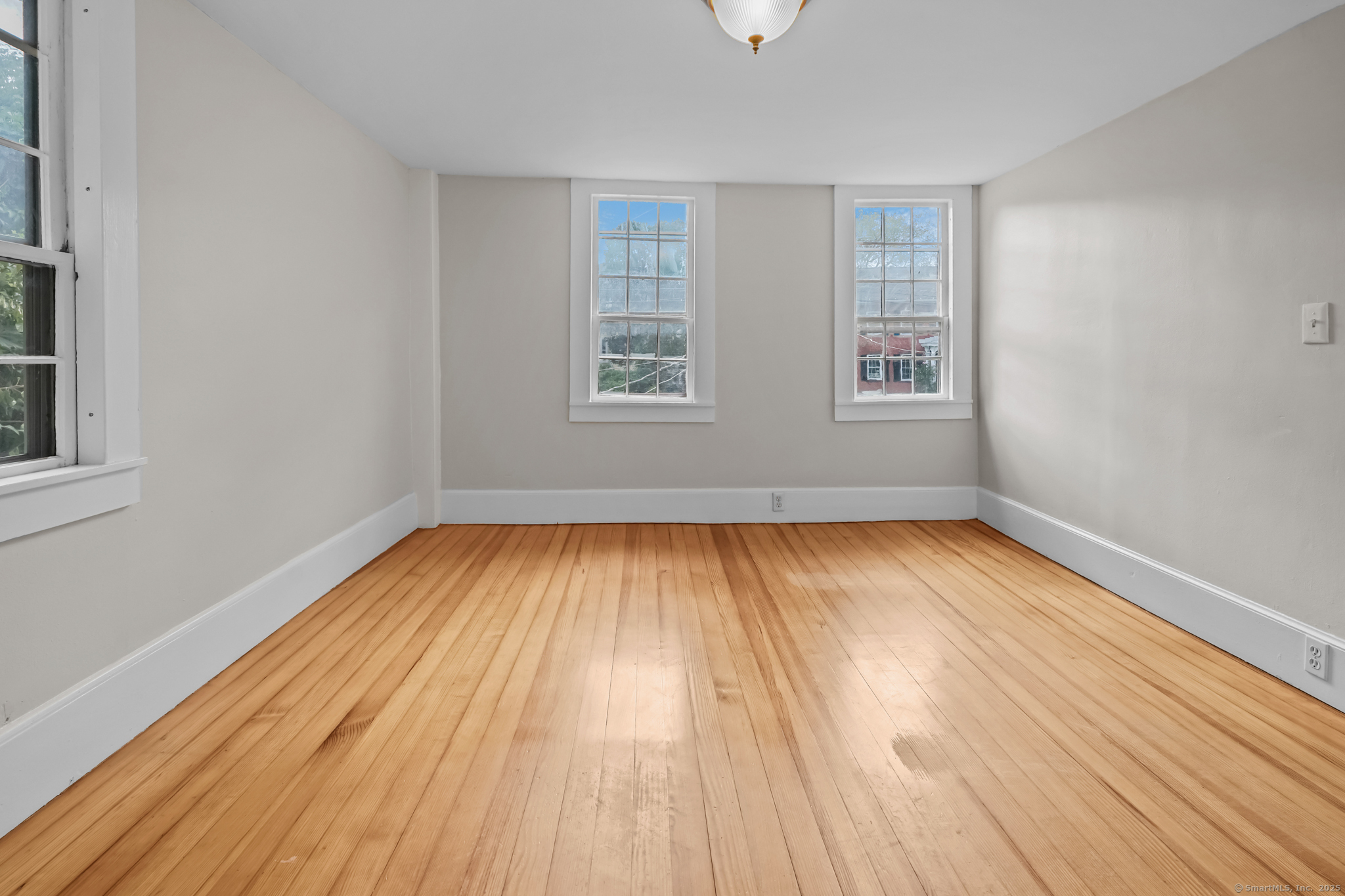 10 North Road Windham, CT 06280 - Photo 34 of 40 an empty room with wooden floor and windows