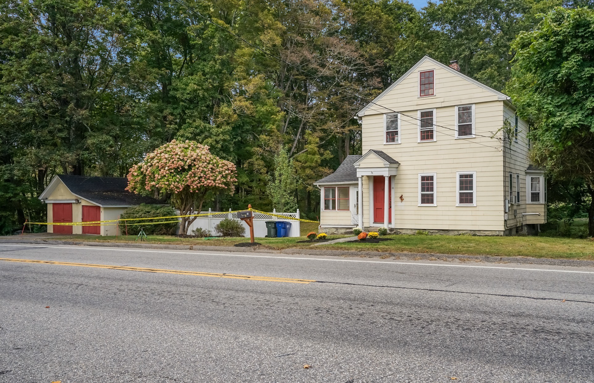 10 North Road Windham, CT 06280 - Photo 4 of 40 a view of a house with a yard and large trees