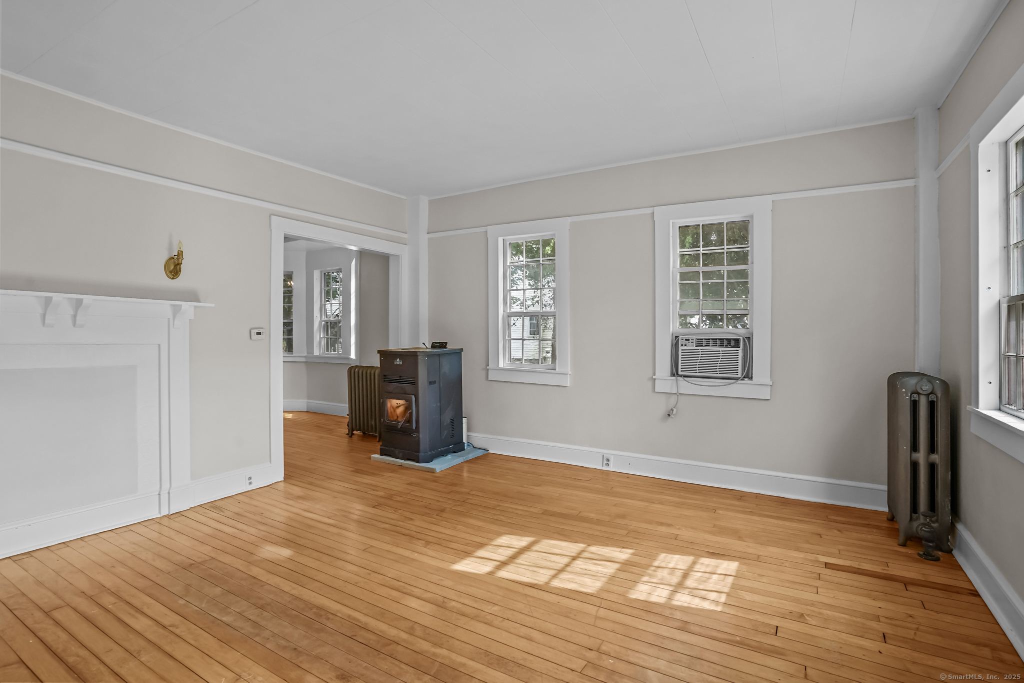 10 North Road Windham, CT 06280 - Photo 7 of 40 a room with a bed and wooden floor