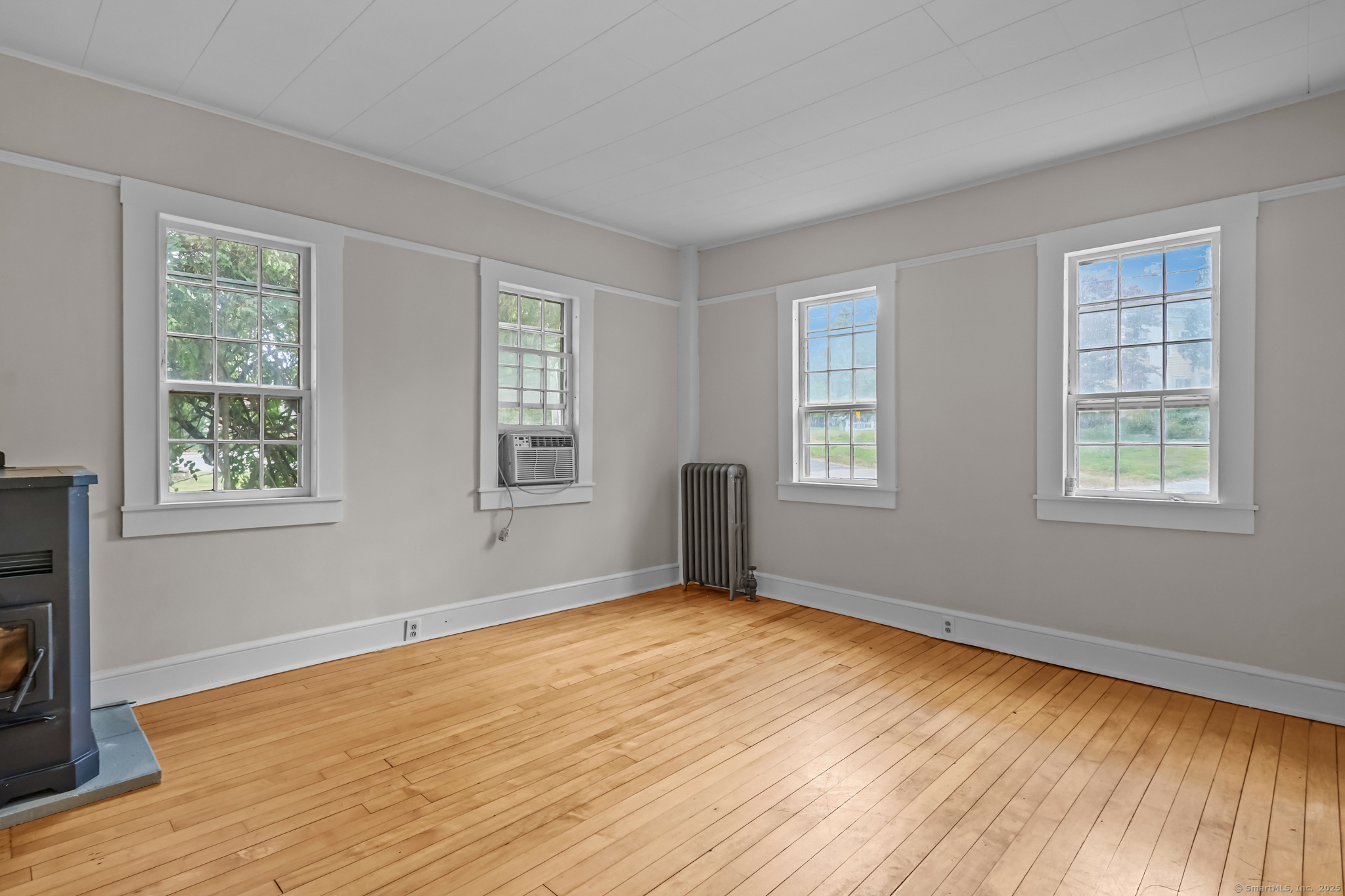 10 North Road Windham, CT 06280 - Photo 9 of 40 a view of an empty room with wooden floor and a window
