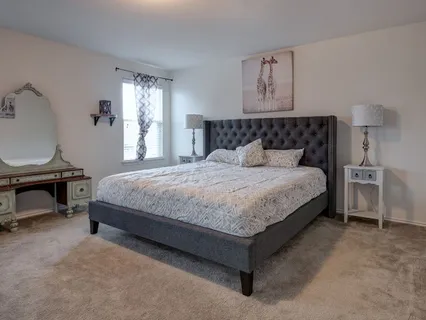 a bedroom with a bed chair and a window