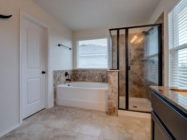 a bathroom with a bathtub and a shower