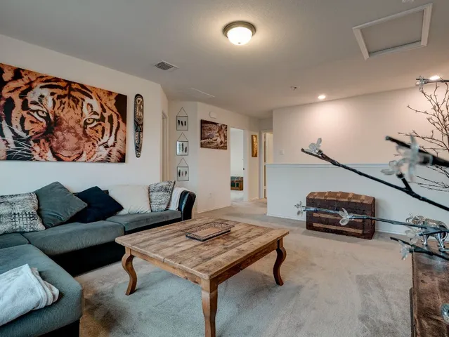a living room with furniture and a rug