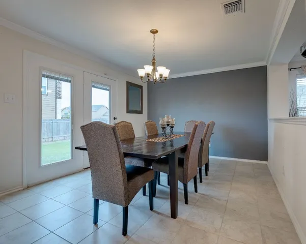 a dining room with furniture and window