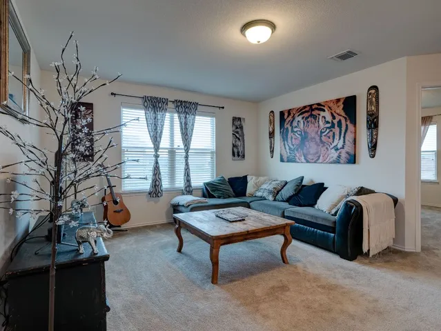 a living room with furniture and a large window