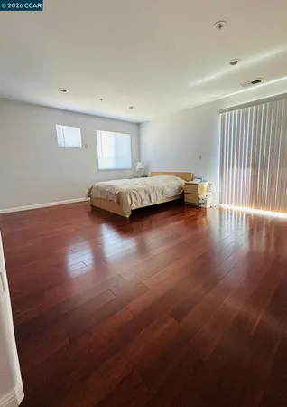a view of room with hardwood floor and window