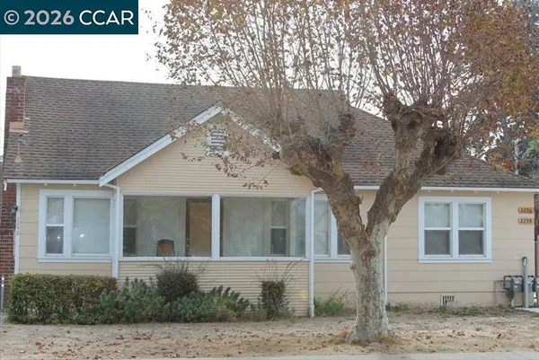 a front view of a house with trees