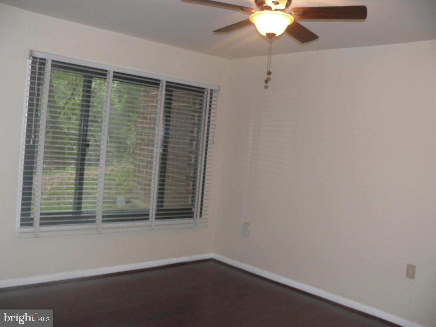 15712 Dorset Road, Unit T3 Laurel, MD 20707 - Photo 18 of 19 a view of wooden floor and a chandelier fan