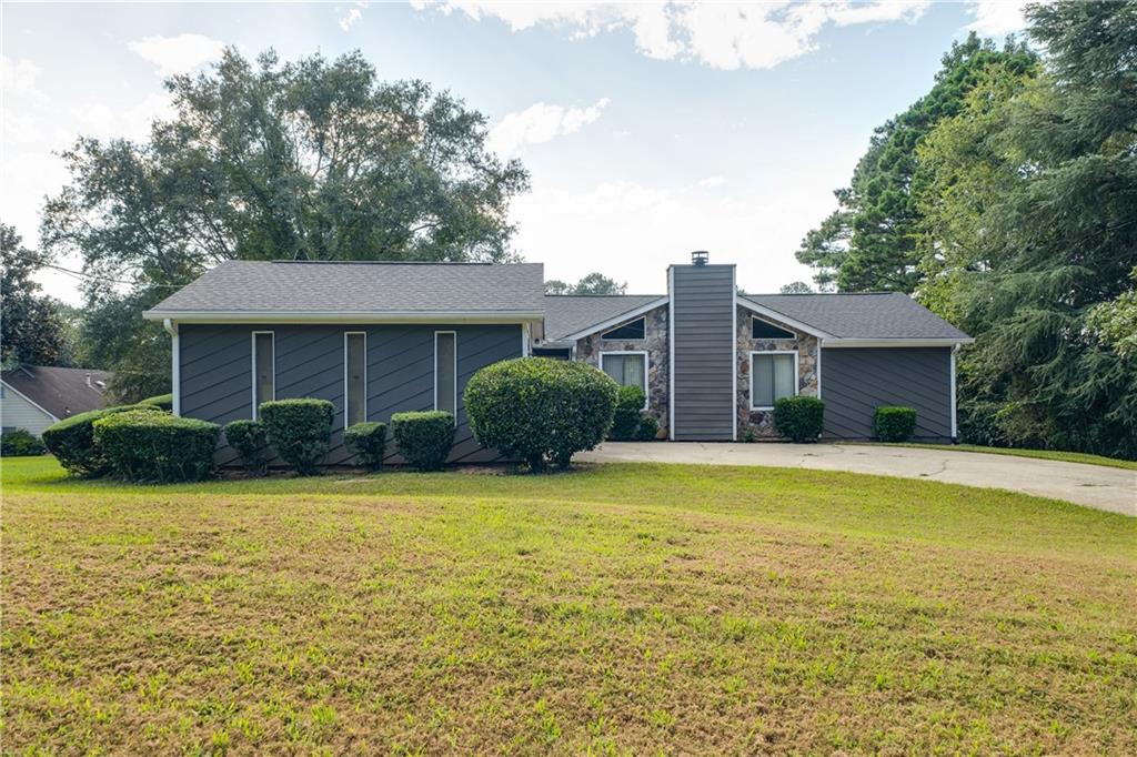 3503 Valley Oaks Road Stonecrest, GA 30038 - Photo 1 of 1 a front view of a house with a yard and garage