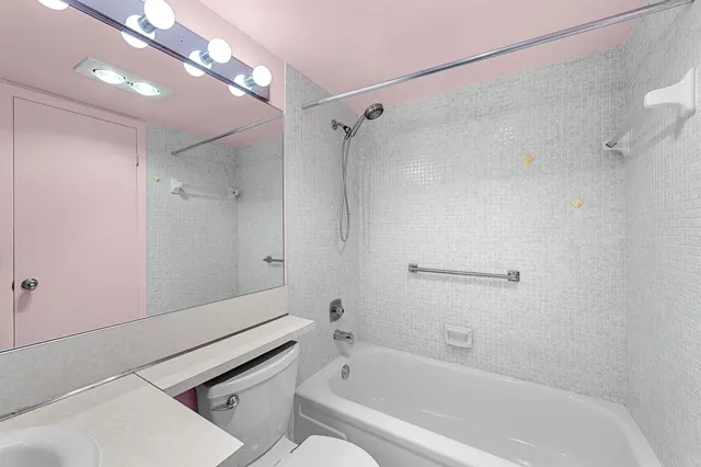 a bathroom with a bathtub and a shower