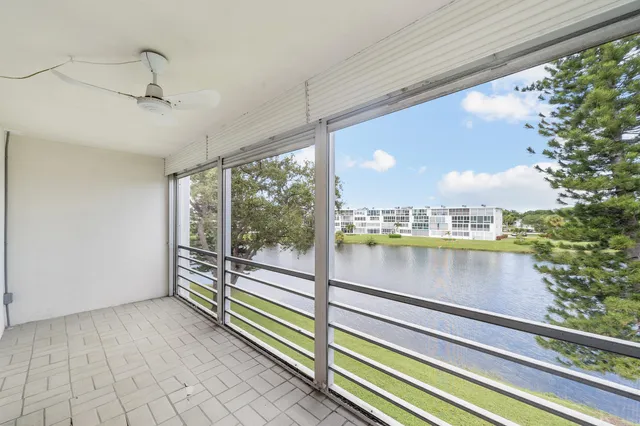 a view of a balcony with floor to ceiling windows and wooden floor