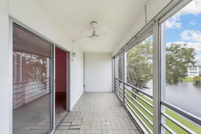a view of a room with wooden floor and windows