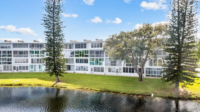 a view of a swimming pool with a yard and sitting area