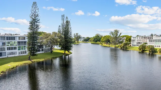 a view of a lake with houses in the back