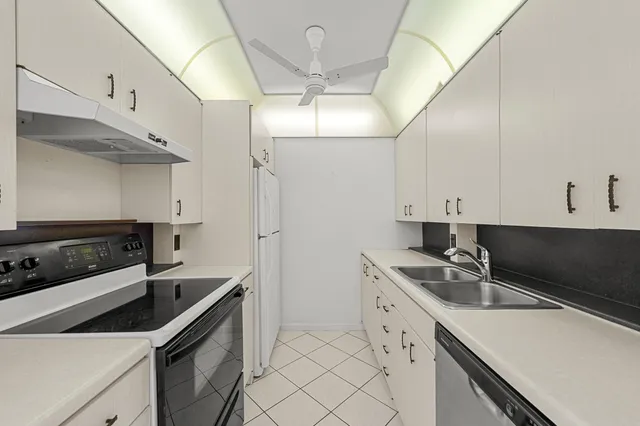 a kitchen that has a sink and a stove