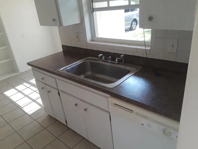 a close view of sink a mirror and window