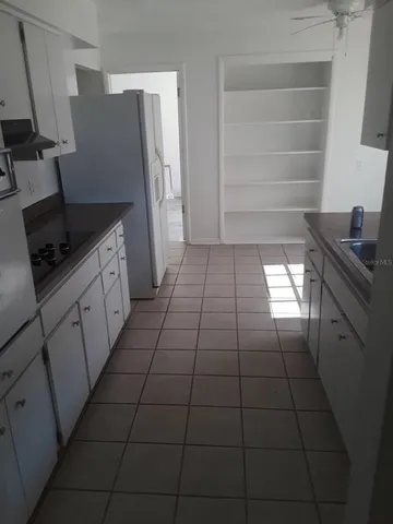 a kitchen with a sink a stove and refrigerator