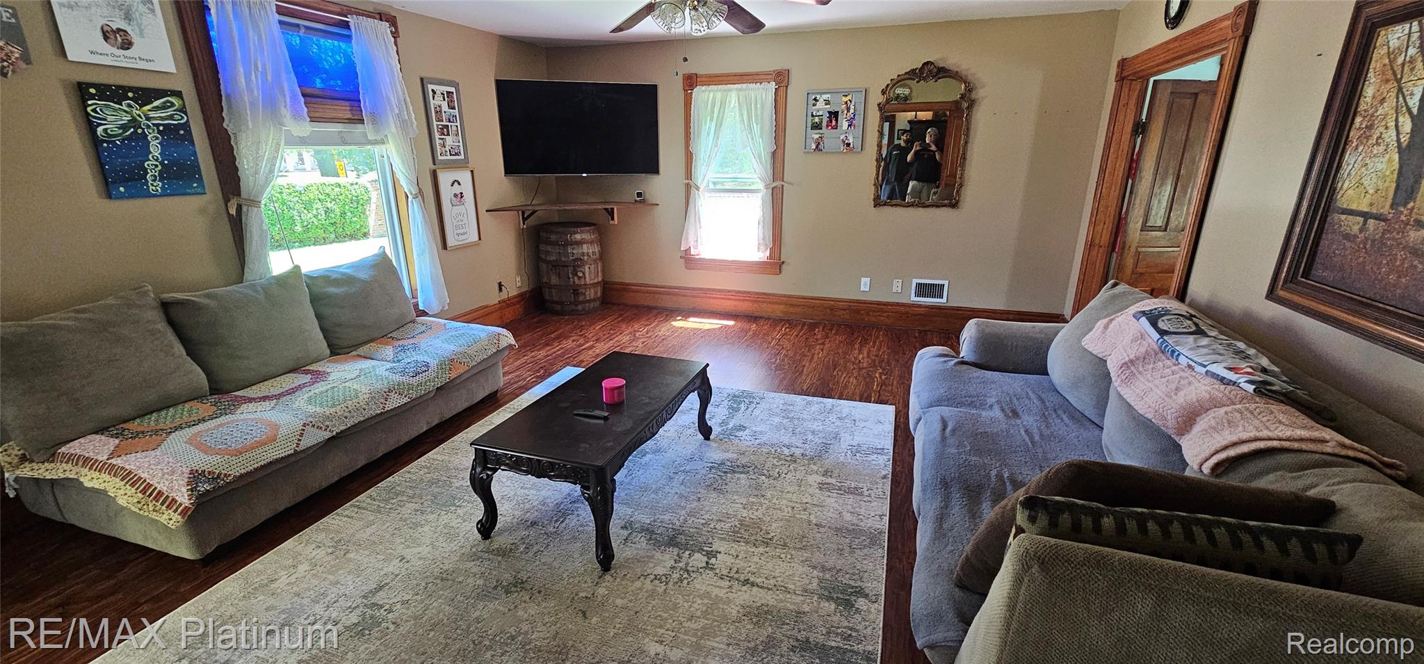 17140 Haggerty Road Belleville, MI 48111 - Photo 17 of 42 Living room featuring wood-finish flooring, two window openings, and a ceiling fan