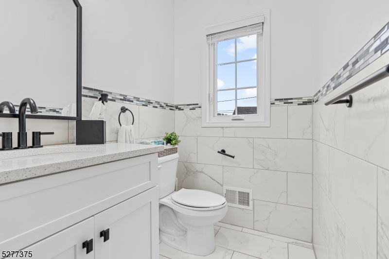 38 Center Street Belleville, NJ 07109 - Photo 15 of 22 a bathroom with a toilet sink and mirror