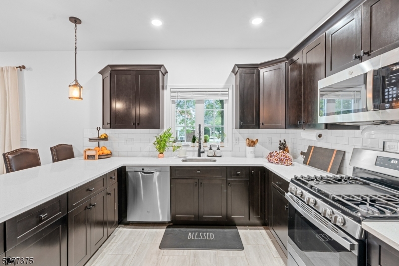 38 Center Street Belleville, NJ 07109 - Photo 3 of 22 a kitchen with a sink stainless steel appliances and cabinets