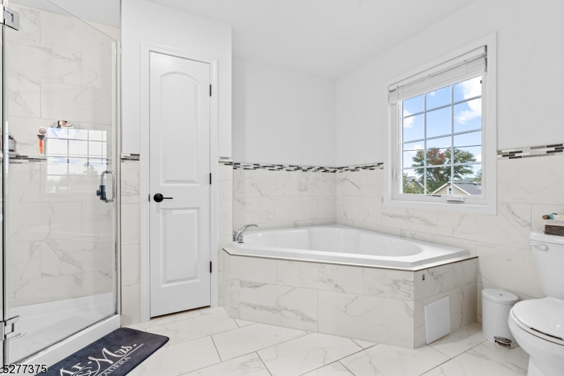 38 Center Street Belleville, NJ 07109 - Photo 6 of 22 a white toilet sitting next to a bathroom