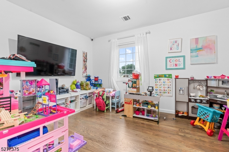 38 Center Street Belleville, NJ 07109 - Photo 10 of 22 a children room with toys and a flat screen tv