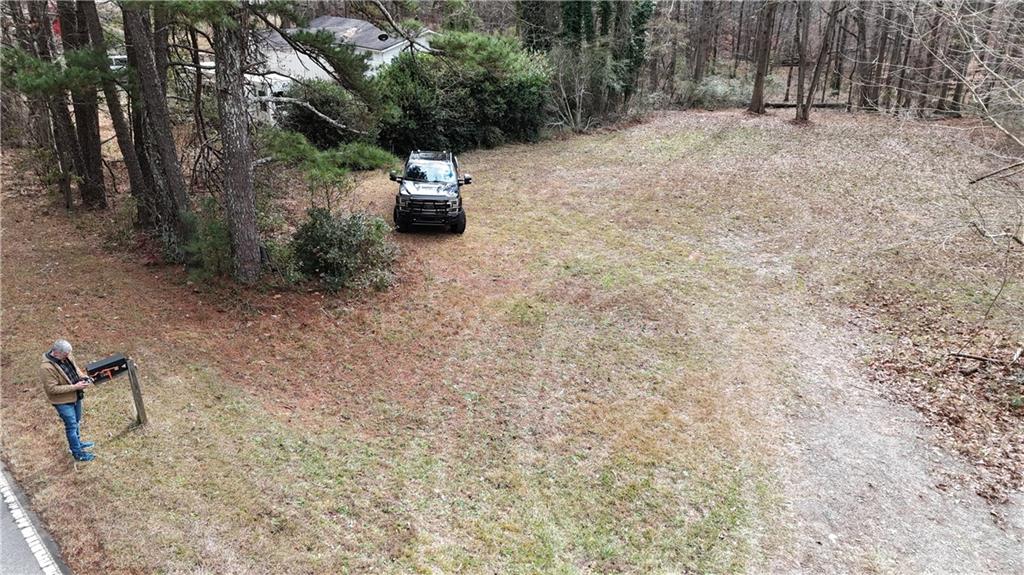 7307 Williams Road Flowery Branch, GA 30542 - Photo 11 of 30 a backyard of a house with lots of green space and seating